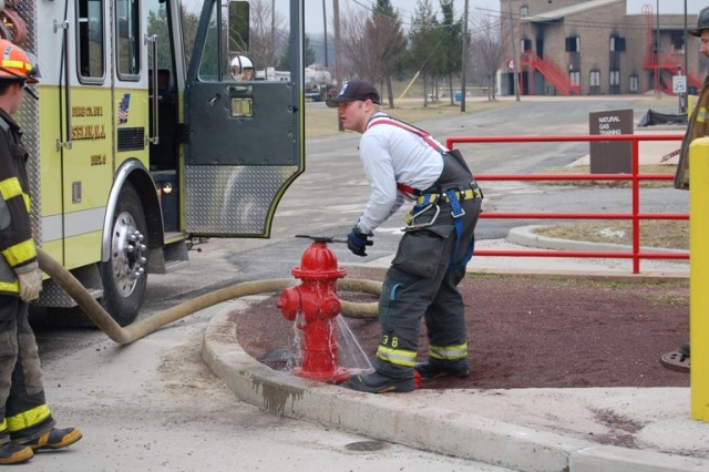 Apparatus Operator FF/EMT Geary opens up the hydrant at a live burn drill.